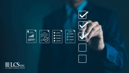 Business professional checking off compliance documents illustrating due diligence processes.